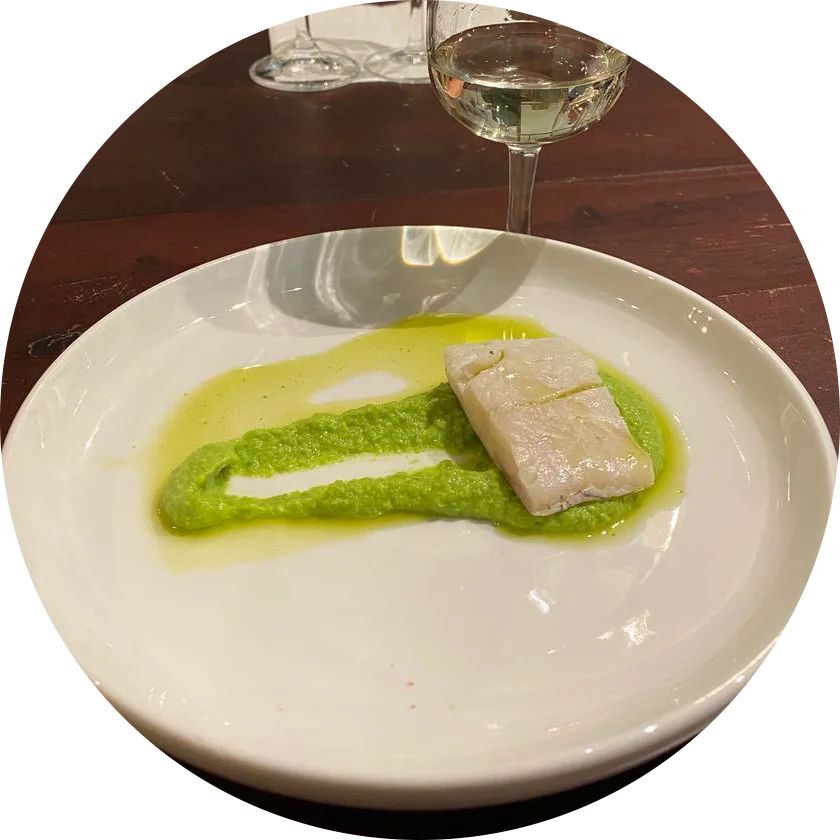 White fish on a swoosh of pea purée and green oil